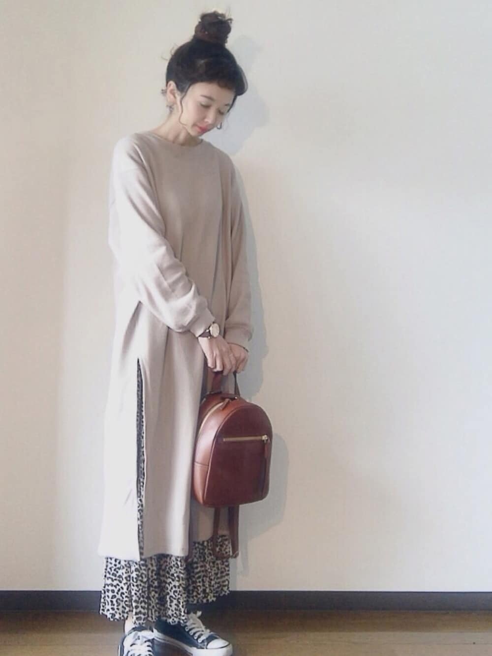 ベージュ系のワンピース、ベージュ系のスカート、ブラウン系のバックパック/リュックを着用したレディースの冬コーディネートの1枚目の写真