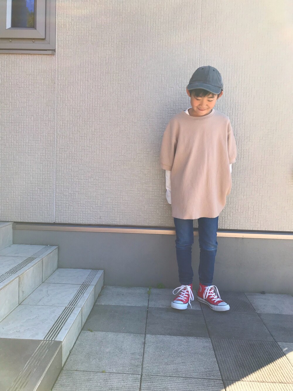 ベージュ系のTシャツ/カットソー、ホワイト系のTシャツ/カットソー、レッド系のスニーカーを着用したキッズの秋コーディネートの1枚目の写真