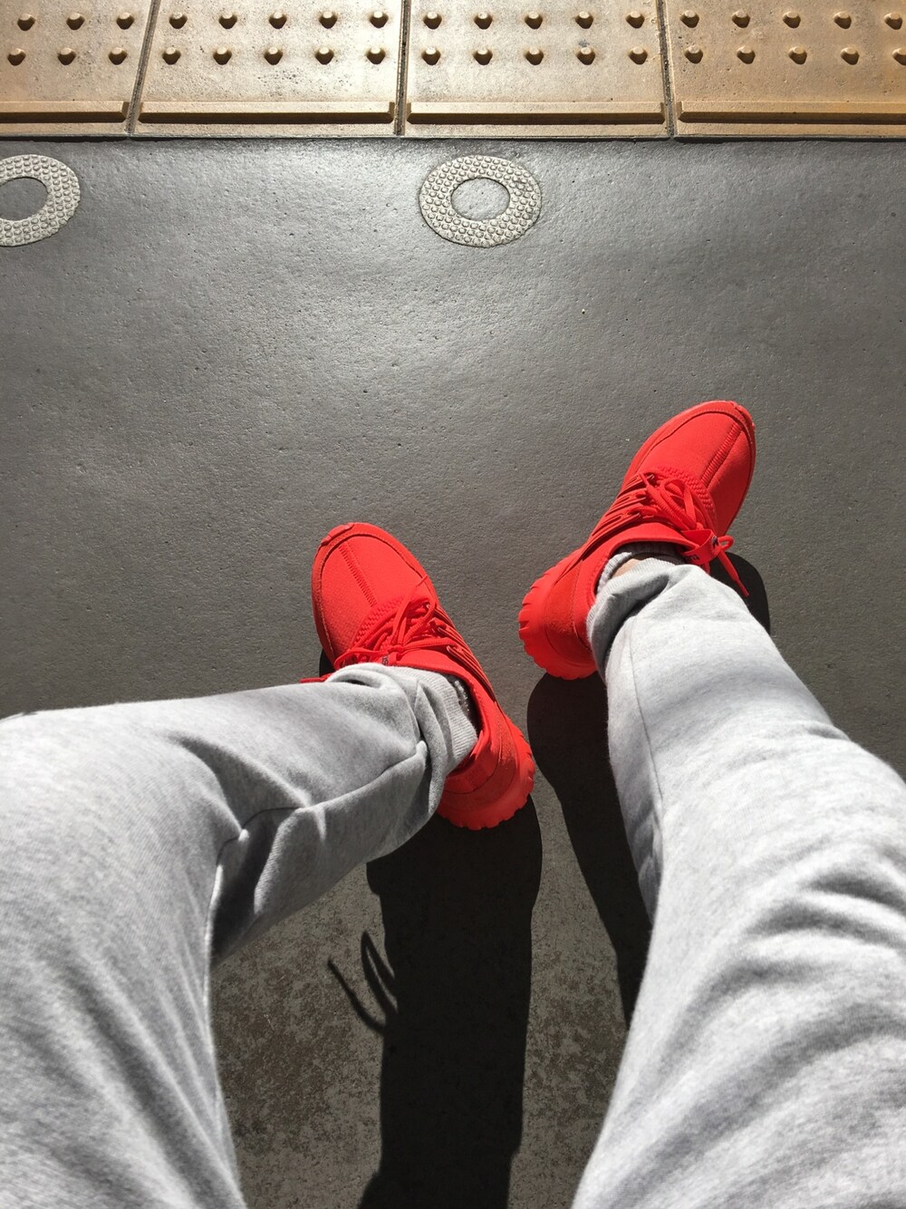 レッド系のスニーカーを着用したメンズの冬コーディネートの1枚目の写真