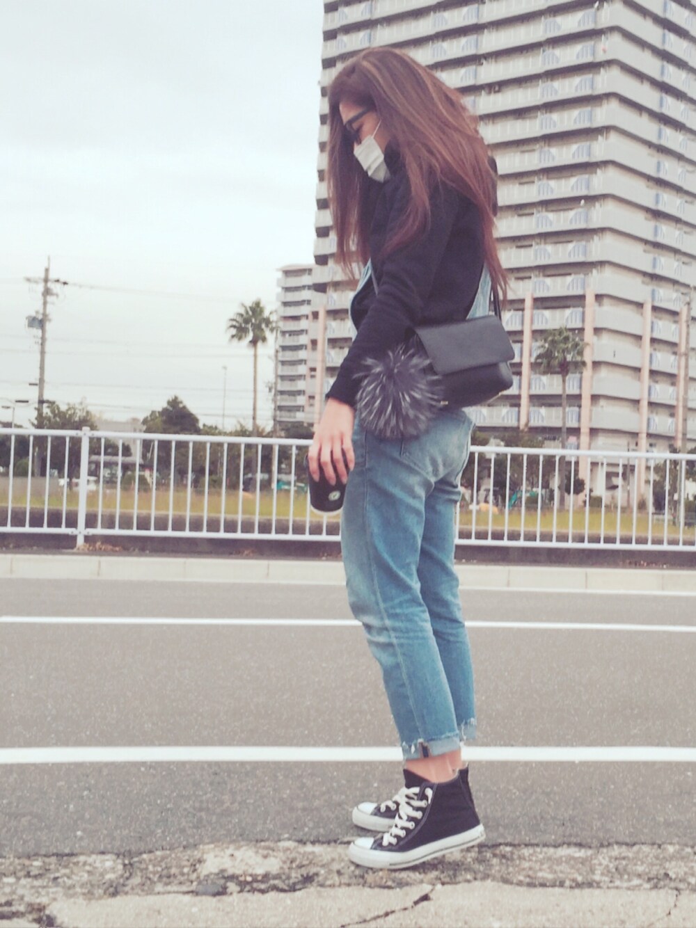 ブラック系のスニーカーを着用したレディースの冬コーディネートの1枚目の写真