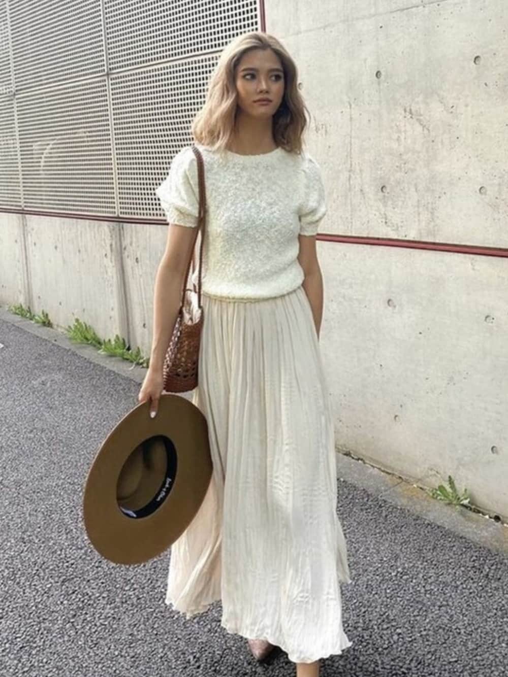 ホワイト系のニット/セーター、ホワイト系のスカートを着用したレディースの夏コーディネートの1枚目の写真