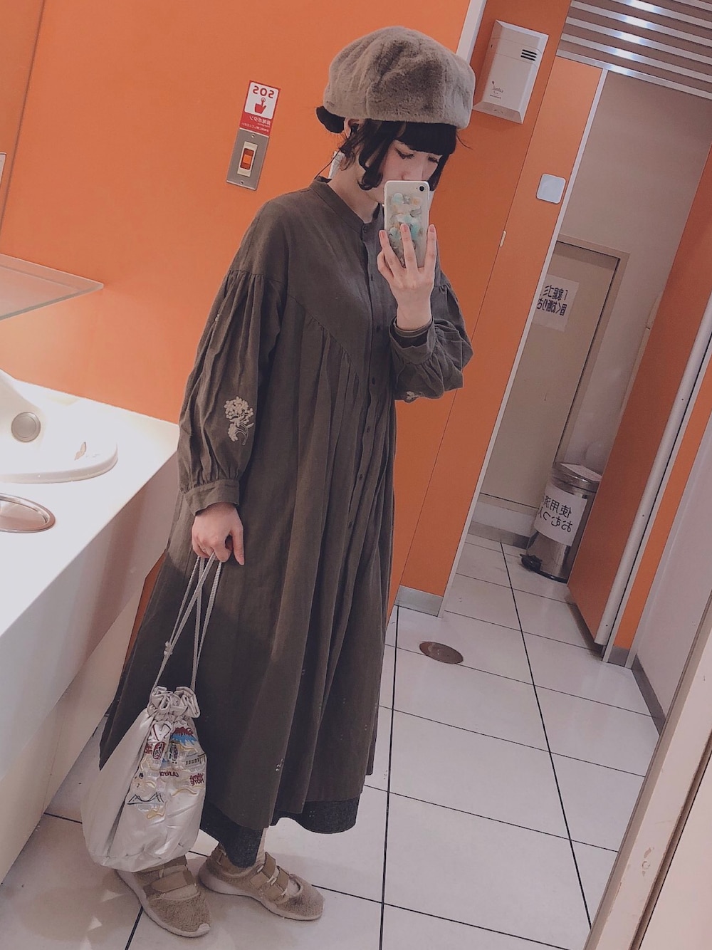 グリーン系のワンピースを着用したレディースの春コーディネートの1枚目の写真