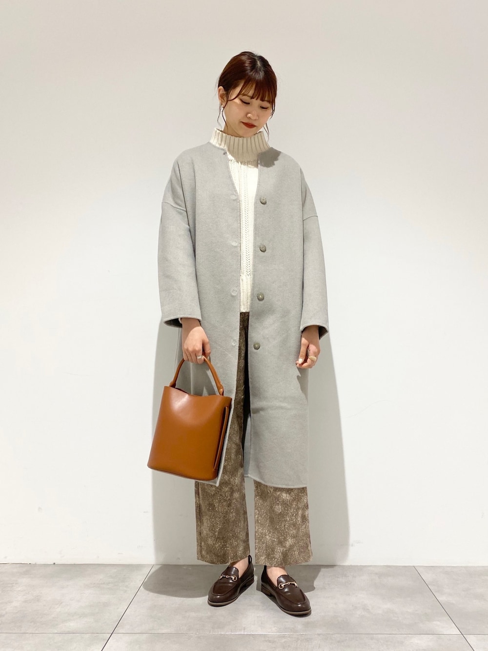 グリーン系のノーカラージャケット、ブラウン系のその他シューズ、ブラウン系のショルダーバッグを着用したレディースの冬コーディネートの1枚目の写真