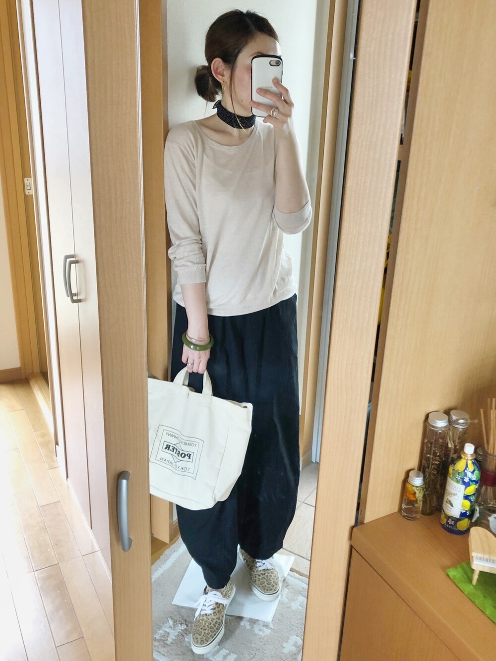 ブラック系のその他パンツ、ベージュ系のニット/セーター、ホワイト系のバッグを着用したレディースの夏コーディネートの1枚目の写真