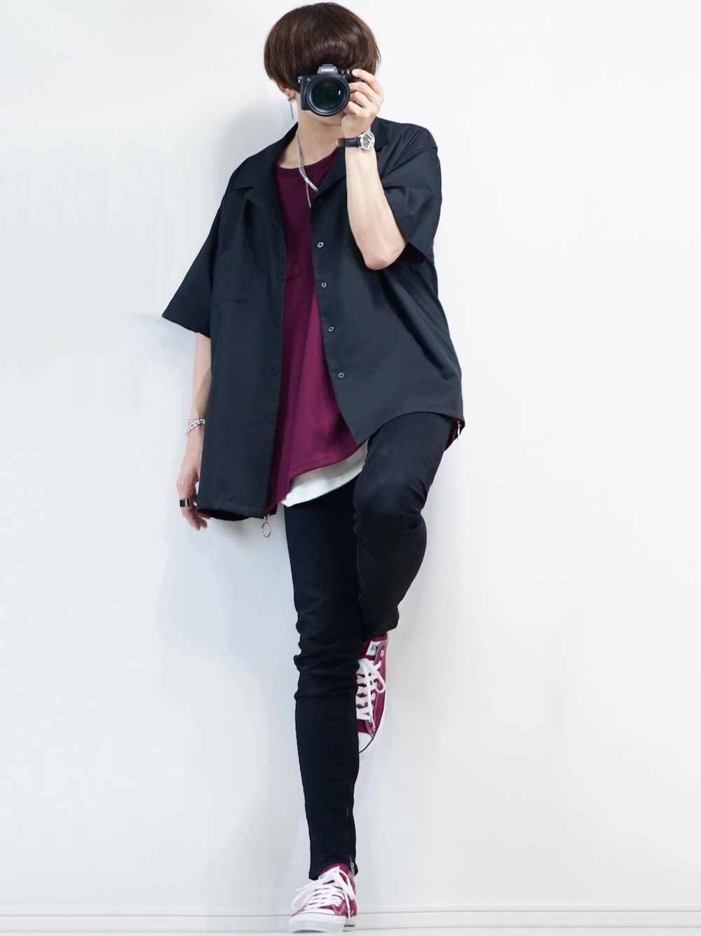 ブラック系のデニムパンツ、レッド系のスニーカー、ホワイト系のタンクトップを着用したメンズの夏コーディネートの1枚目の写真