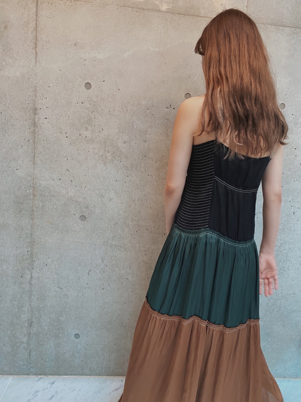 ブラック系のワンピースを着用したレディースの夏コーディネートの1枚目の写真