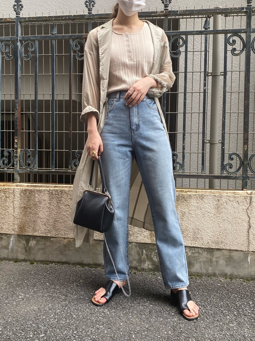 ブルー系のデニムパンツ、ブラック系のショルダーバッグ、ブラック系のサンダルを着用したレディースの夏コーディネートの1枚目の写真