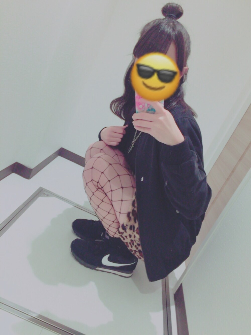 ブラック系のスニーカー、ブラウン系のスカート、ブラック系のブルゾンを着用したレディースの冬コーディネートの1枚目の写真