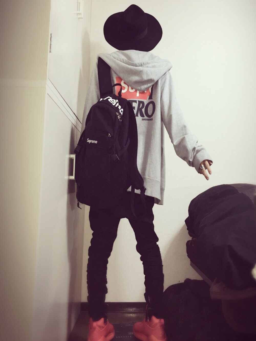 グレー系のパーカー、ブラック系のバックパック/リュック、ホワイト系のTシャツ/カットソーを着用したメンズの冬コーディネートの1枚目の写真