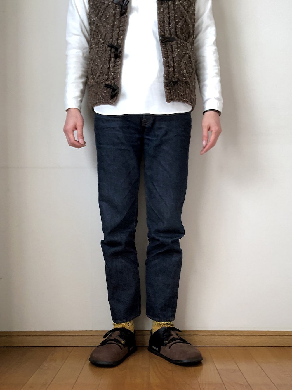 ブラウン系のベスト、ホワイト系のシャツ/ブラウス、ブラウン系のスニーカーを着用したメンズの春コーディネートの1枚目の写真