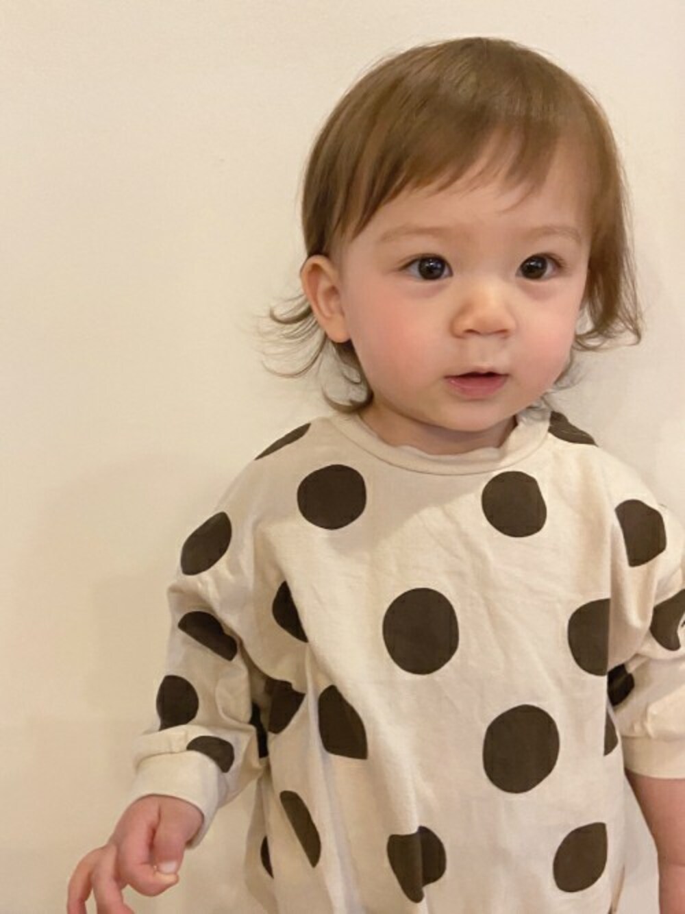 ベージュ系のロンパースを着用したキッズの冬コーディネートの1枚目の写真