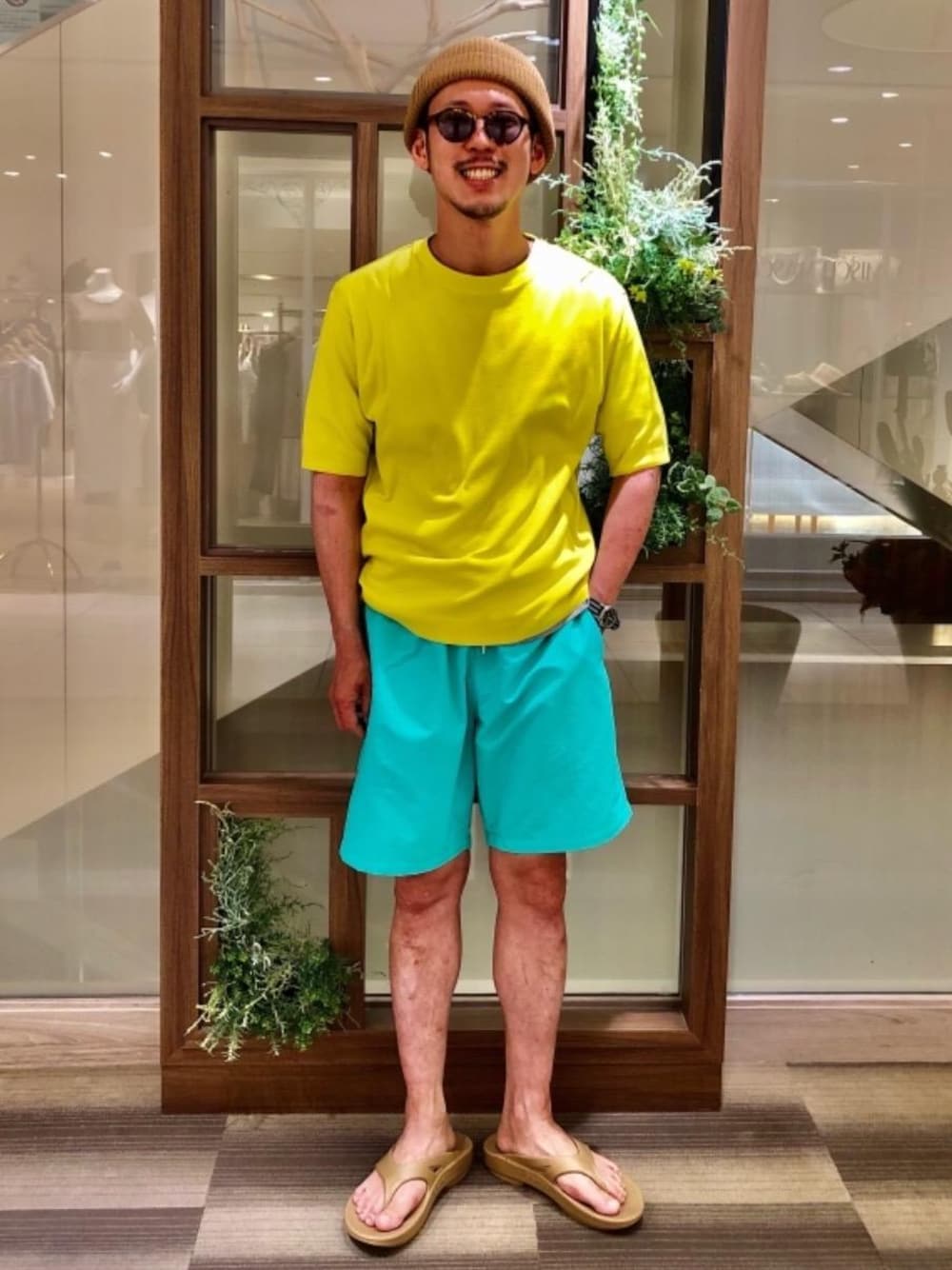 グリーン系のその他パンツ、イエロー系のニット/セーター、ベージュ系のサンダルを着用したメンズの夏コーディネートの1枚目の写真