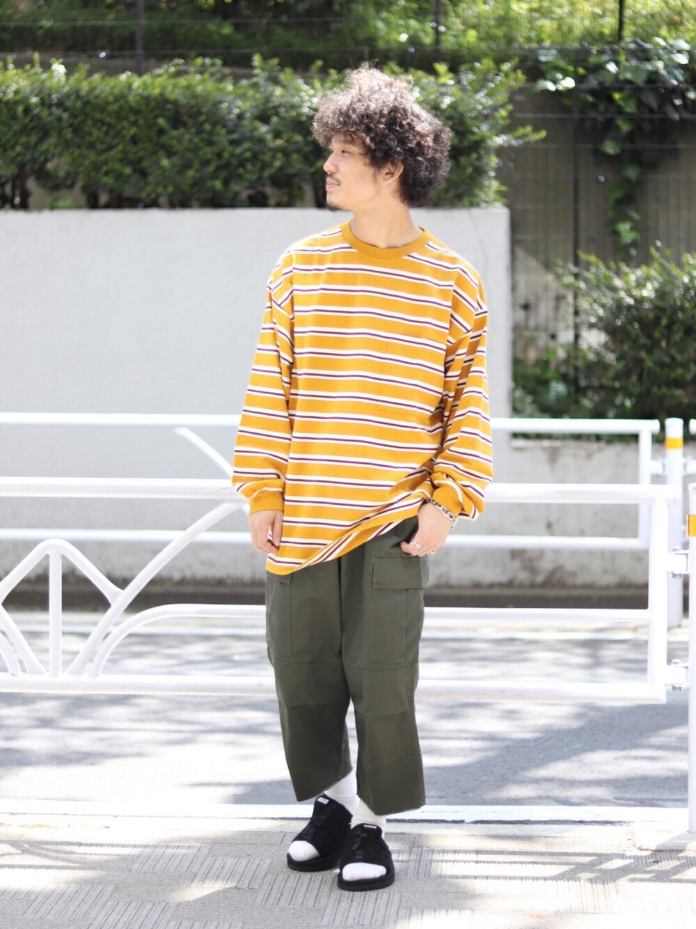 イエロー系のTシャツ/カットソー、グリーン系のカーゴパンツを着用したメンズの春コーディネートの1枚目の写真