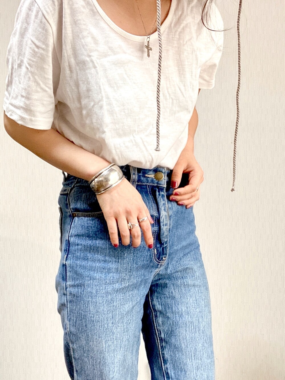 ホワイト系のTシャツ/カットソー、ブルー系のパンツ、シルバー系のアクセサリーを着用したレディースの春コーディネートの1枚目の写真