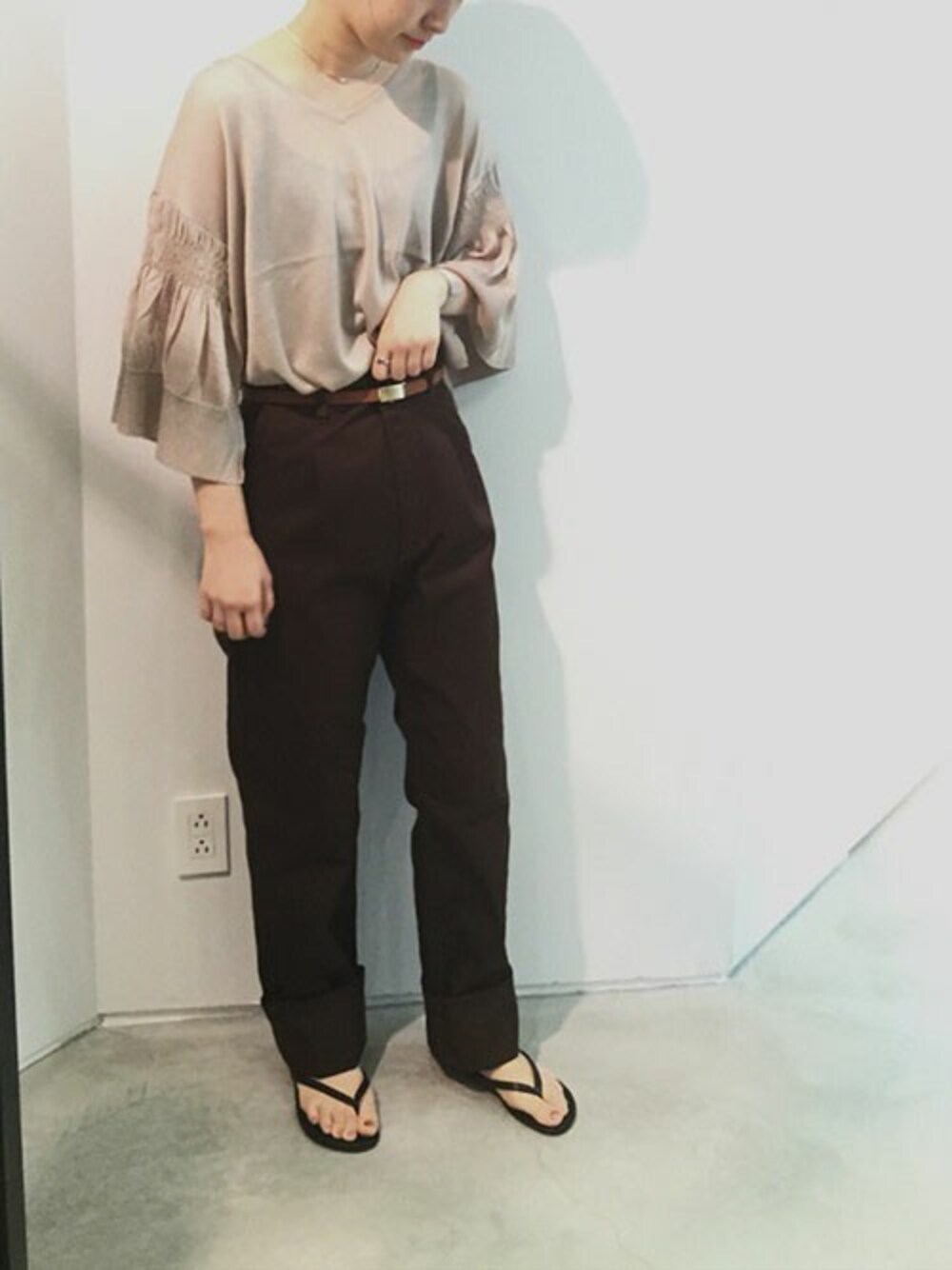 ベージュ系のニット/セーター、ブラウン系のベルトを着用したレディースの夏コーディネートの1枚目の写真