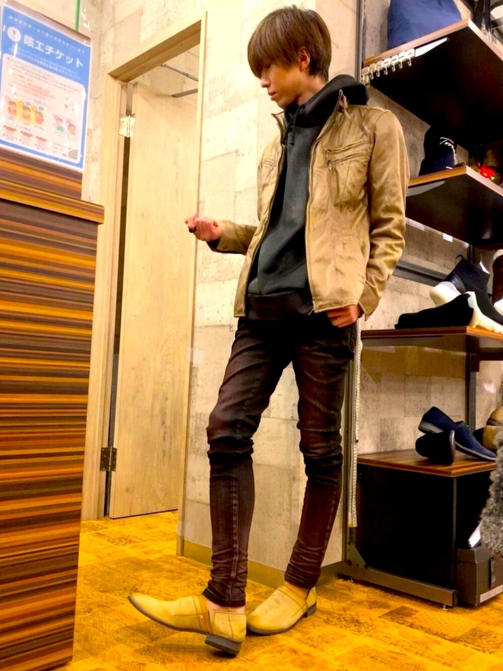 レッド系のデニムパンツ、ベージュ系のスリッポン、ブラック系のTシャツ/カットソーを着用したメンズの冬コーディネートの1枚目の写真