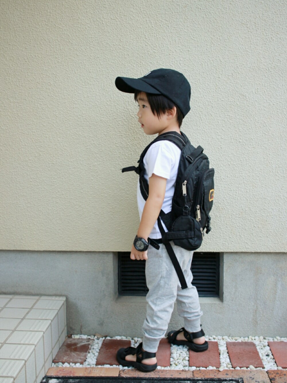 ブラック系のタンクトップ、ホワイト系のTシャツ/カットソー、ブラック系のバックパック/リュックを着用したキッズの夏コーディネートの1枚目の写真