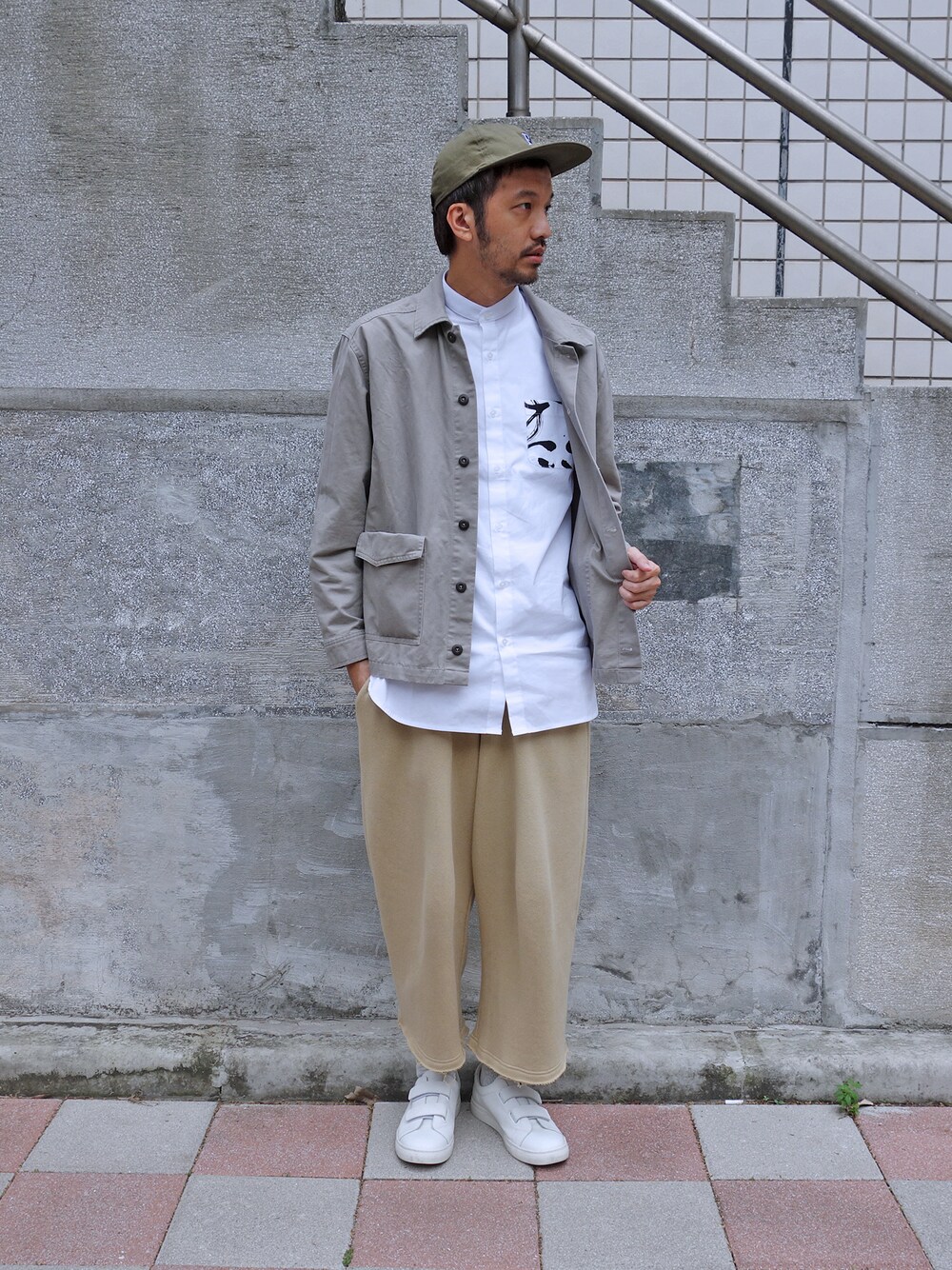 グリーン系のキャップを着用したメンズの冬コーディネートの1枚目の写真