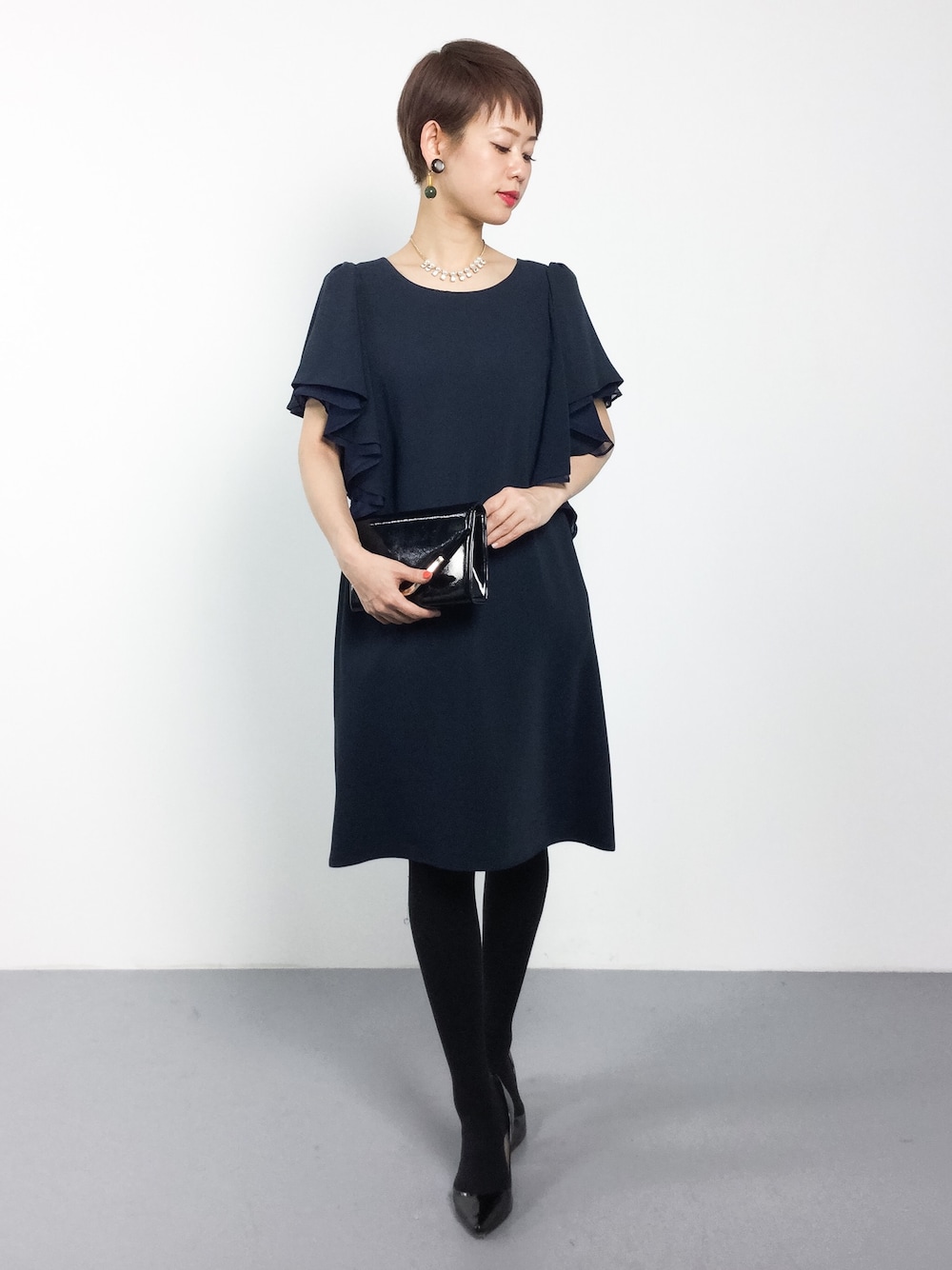 ブルー系のドレスを着用したレディースの冬コーディネートの1枚目の写真