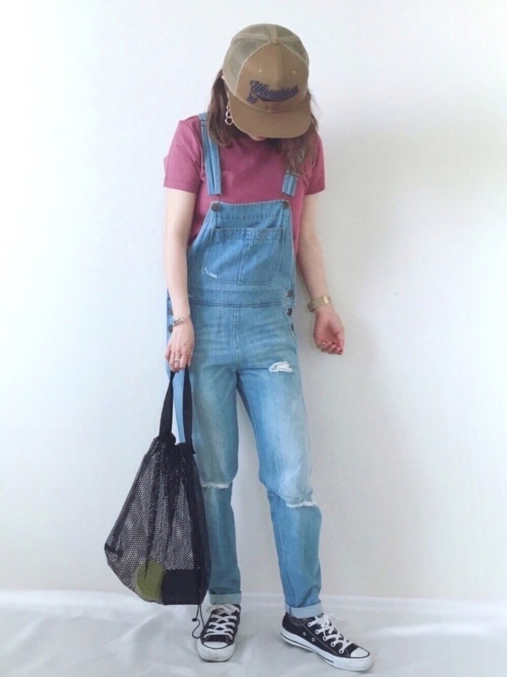 ピンク系のTシャツ/カットソー、ブラック系のスニーカー、ベージュ系のキャップを着用したレディースの春コーディネートの1枚目の写真
