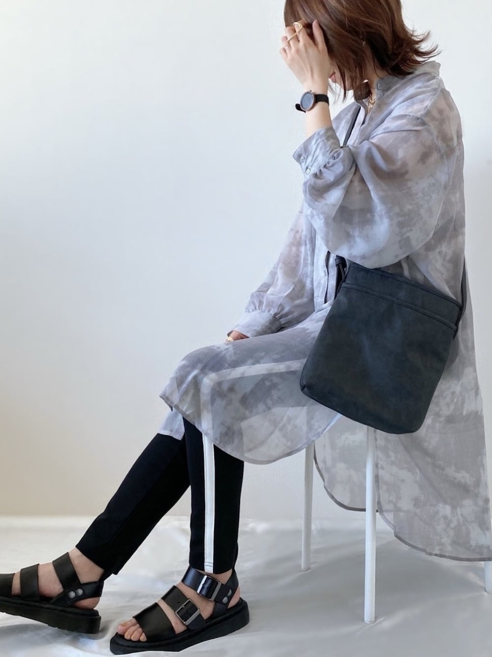 グレー系のシャツ/ブラウス、ブラック系のショルダーバッグ、ブラック系のサンダルを着用したレディースの春コーディネートの1枚目の写真