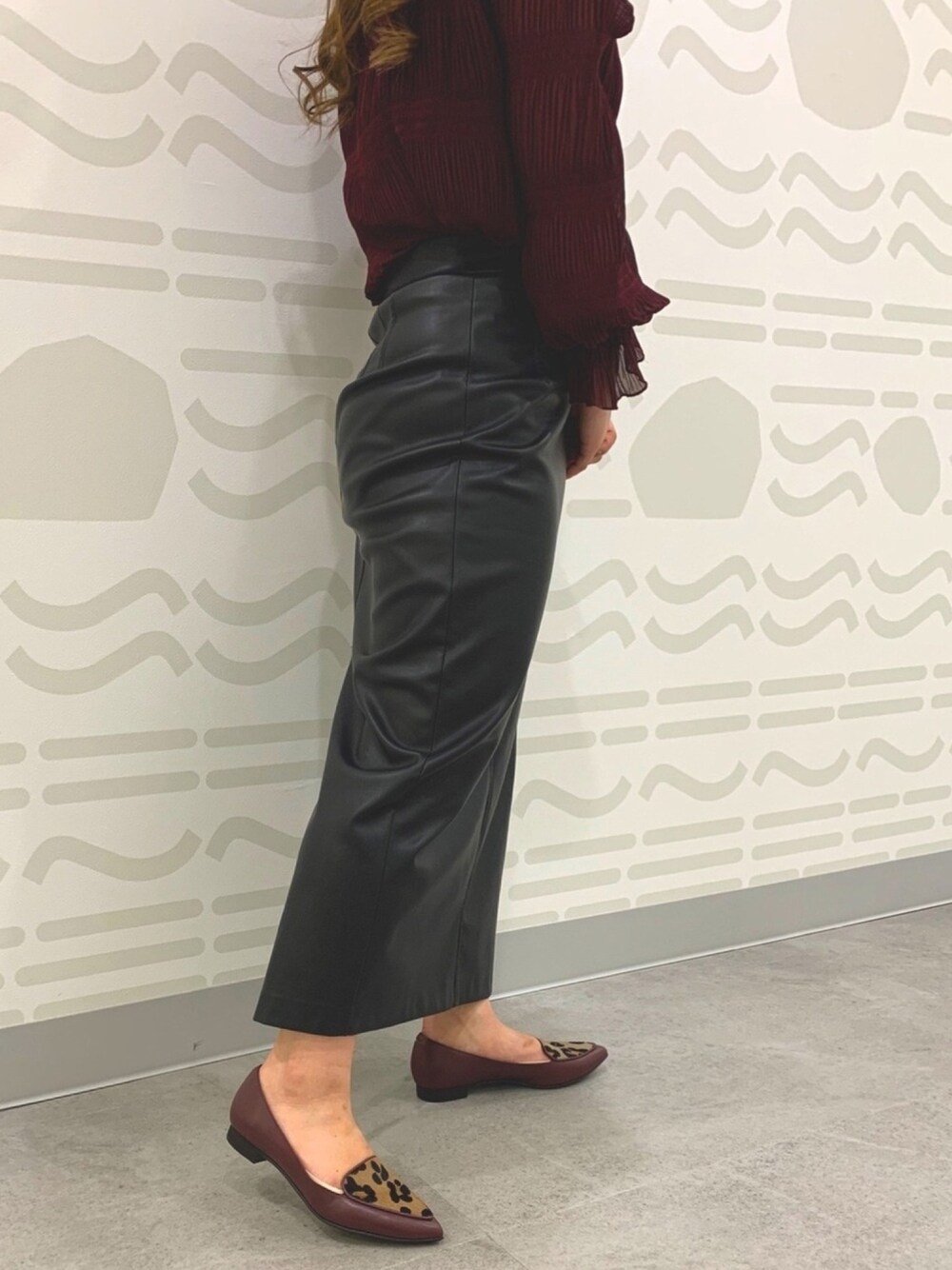 レッド系のパンプスを着用したレディースの冬コーディネートの1枚目の写真