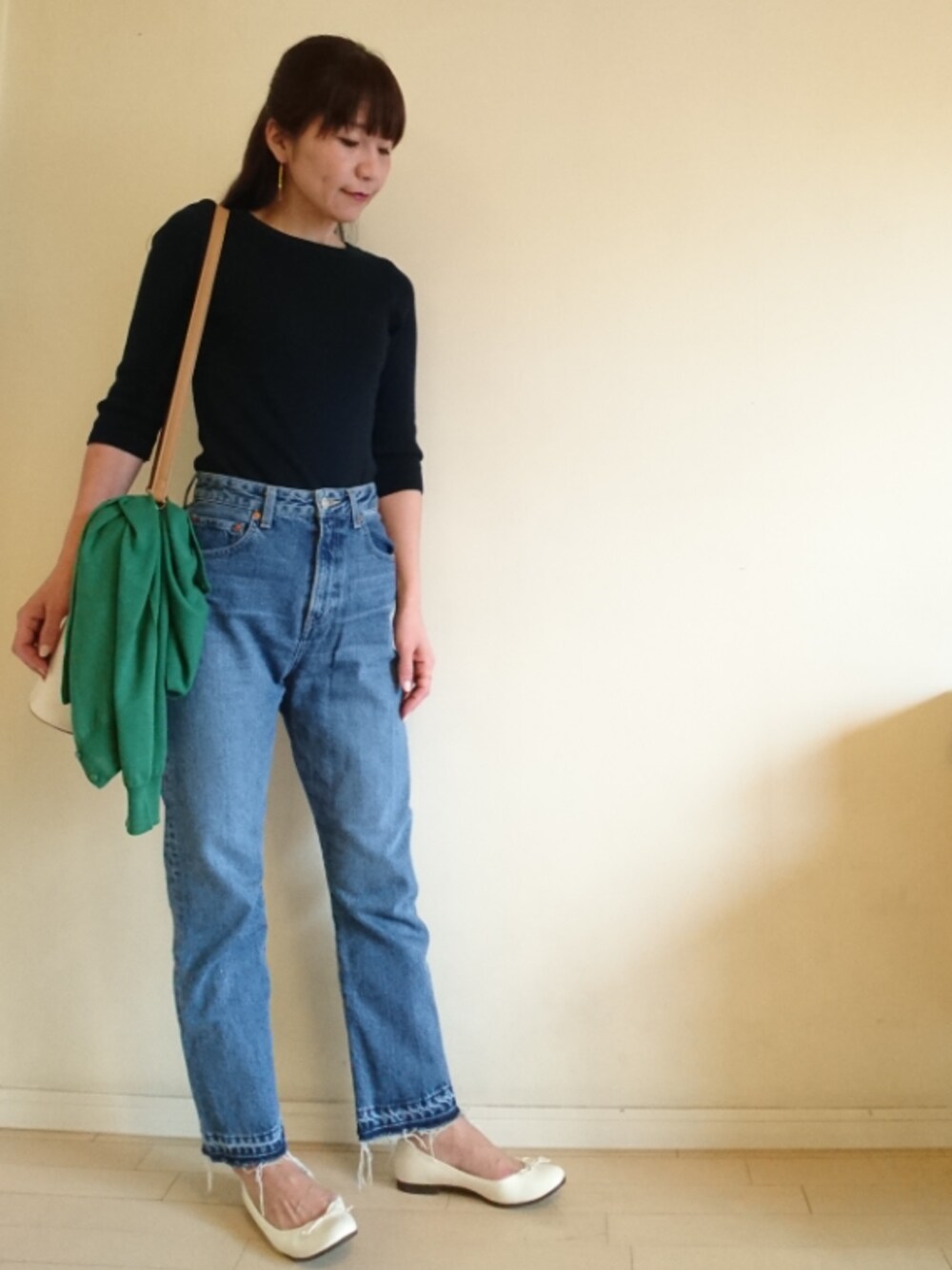 ベージュ系のショルダーバッグ、ブルー系のニット/セーターを着用したレディースの春コーディネートの1枚目の写真