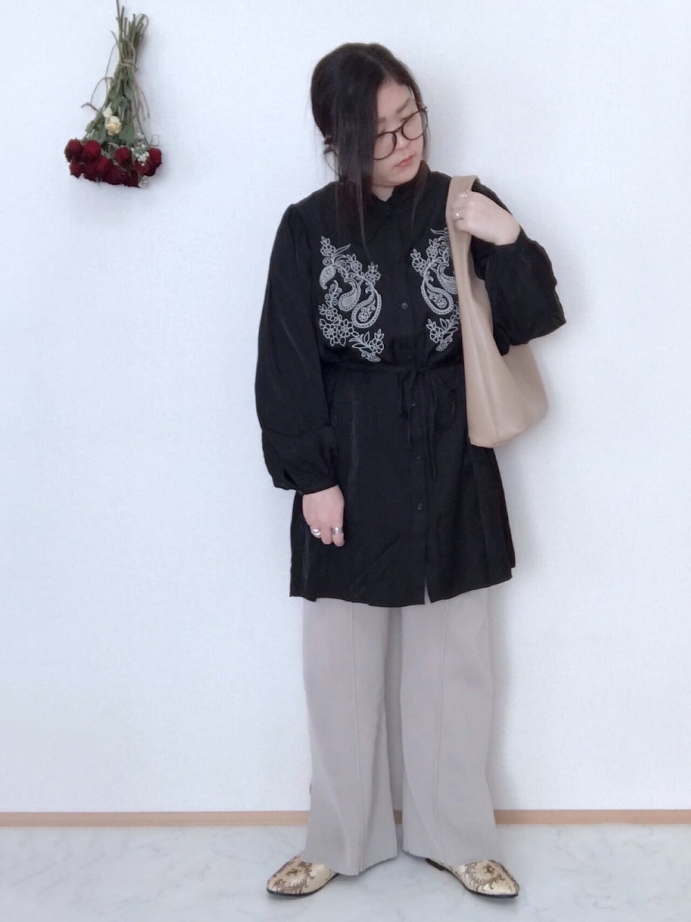 ブラック系のシャツ/ブラウス、ベージュ系のその他パンツ、ベージュ系のトートバッグを着用したレディースの春コーディネートの1枚目の写真