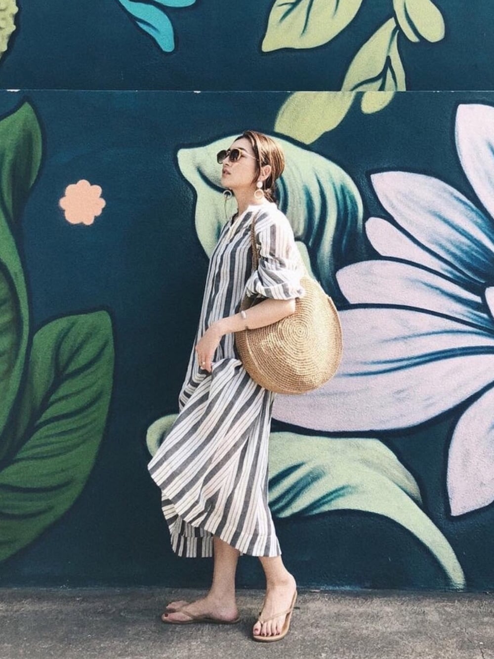 ブラック系のワンピース、ブラウン系のピアス（両耳用）を着用したレディースの春コーディネートの1枚目の写真