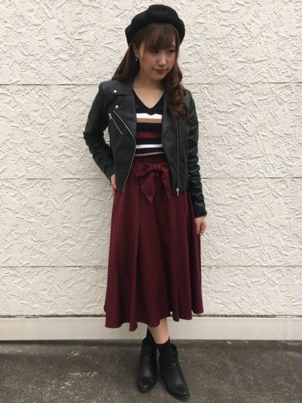 ブルー系のニット/セーター、レッド系のスカートを着用したレディースの秋コーディネートの1枚目の写真