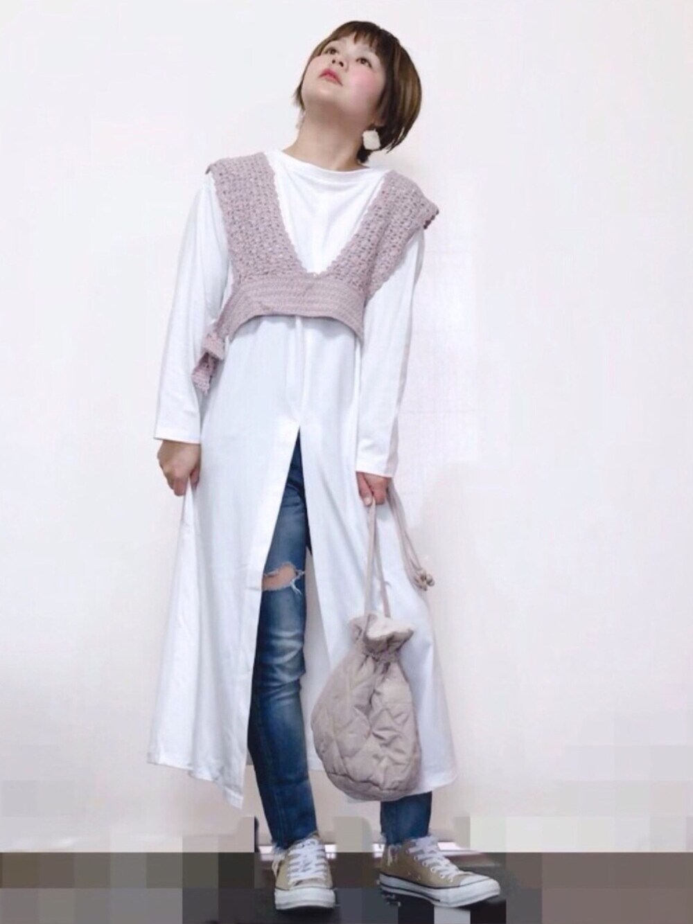 ベージュ系のスニーカー、ブルー系のデニムパンツ、ホワイト系のバッグを着用したレディースの春コーディネートの1枚目の写真