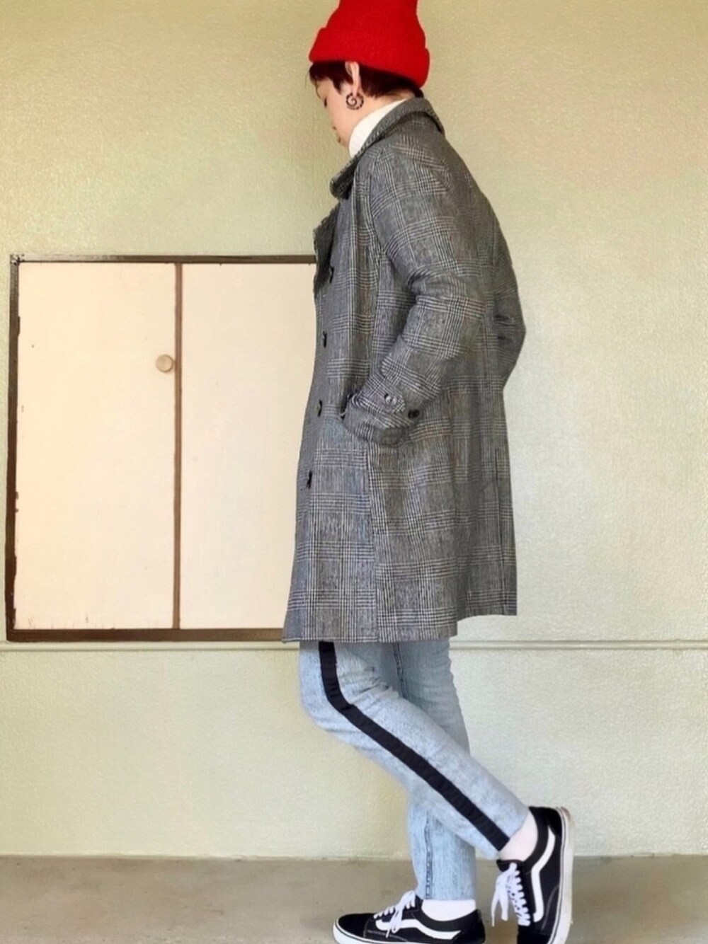 ブラック系のスニーカー、ブルー系のデニムパンツ、ホワイト系のニット/セーターを着用したメンズの冬コーディネートの1枚目の写真