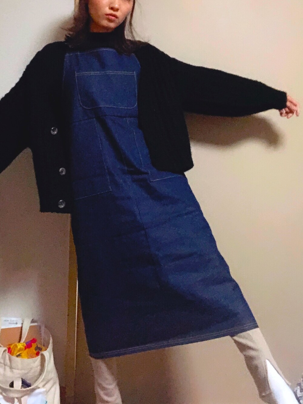 ブルー系のジャンパースカートを着用したレディースの冬コーディネートの1枚目の写真