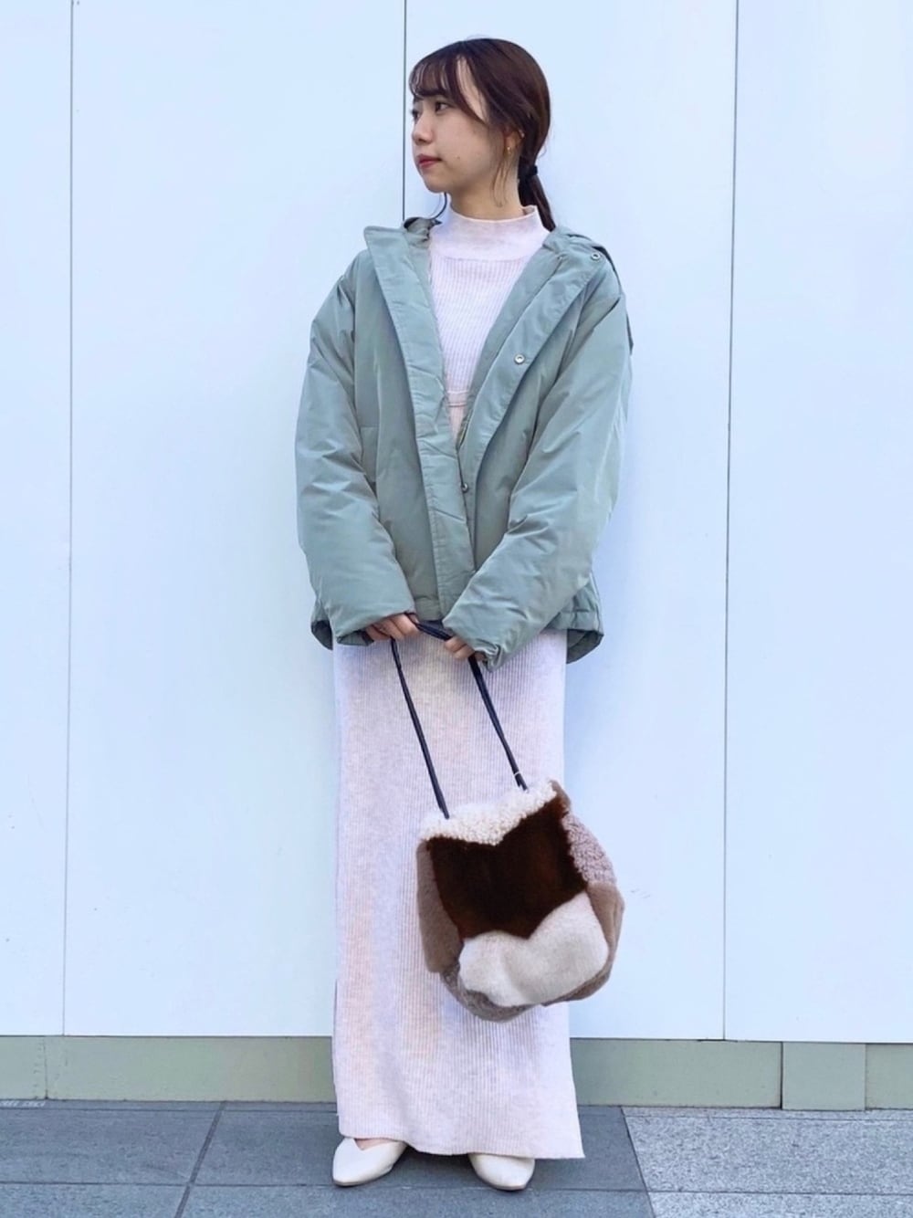 グリーン系のダウンジャケット/コート、ブラウン系のショルダーバッグ、ホワイト系のその他シューズを着用したレディースの冬コーディネートの1枚目の写真