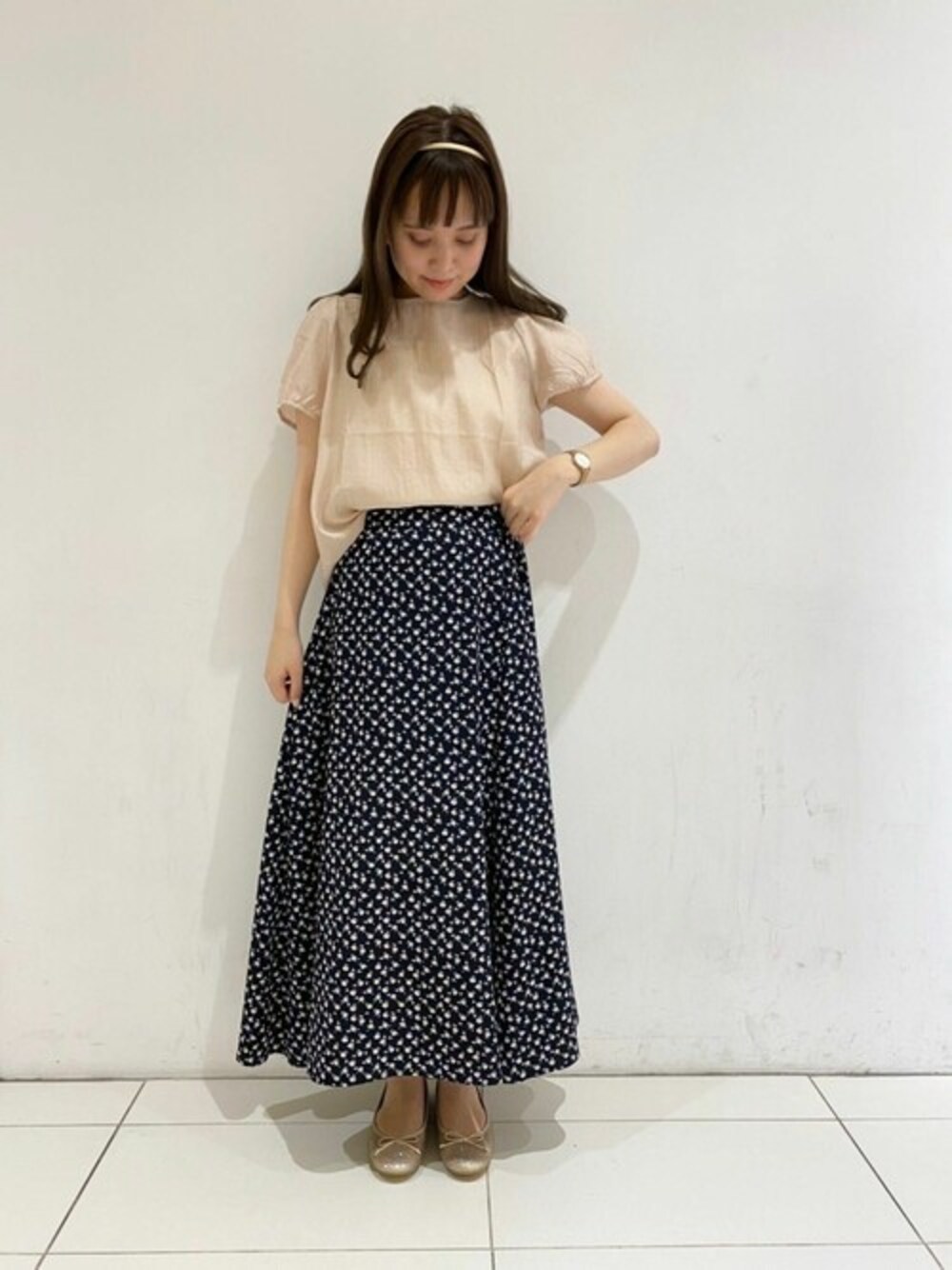 ベージュ系のシャツ/ブラウス、ブラック系のスカートを着用したレディースの春コーディネートの1枚目の写真