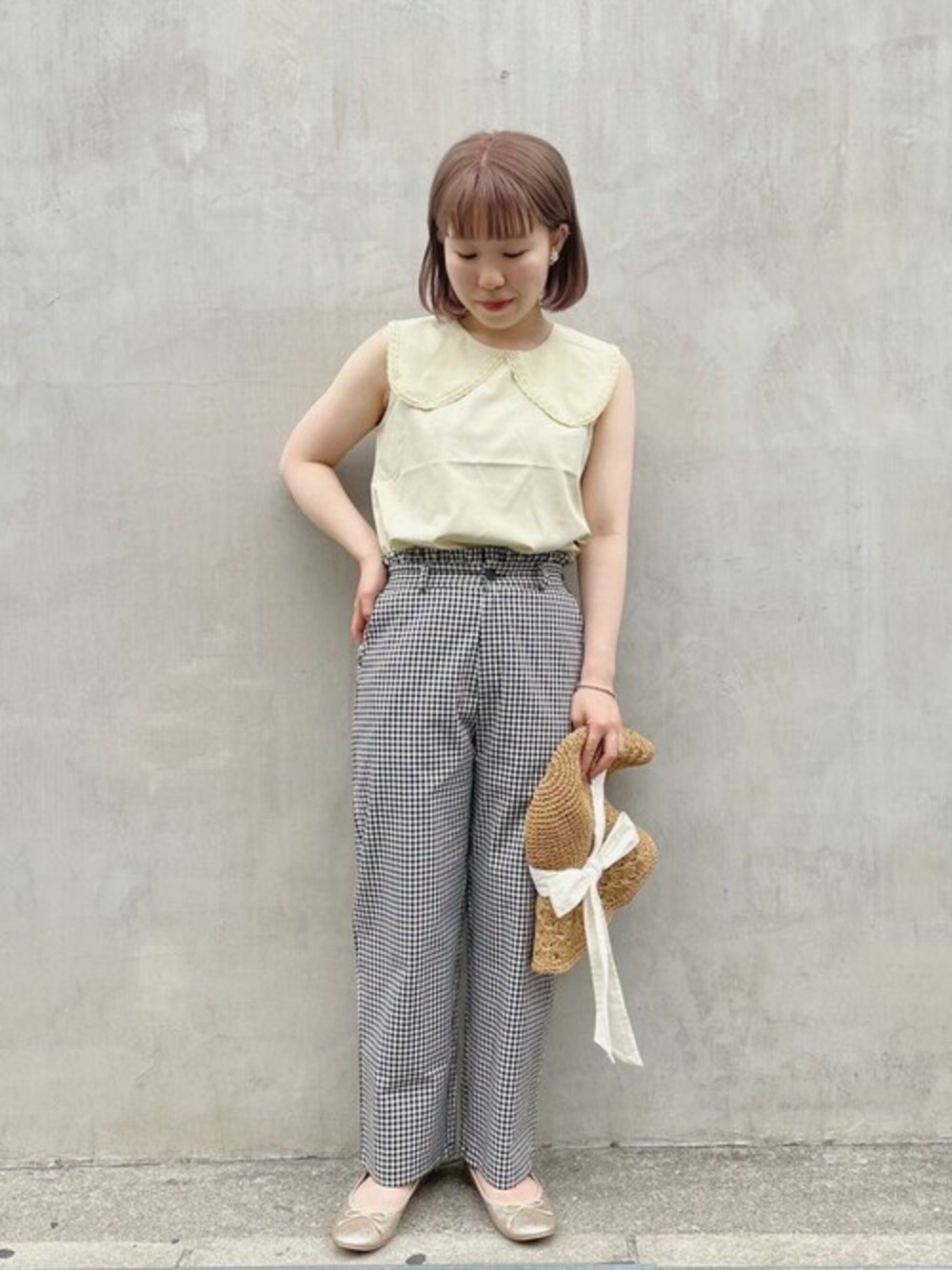 イエロー系のシャツ/ブラウス、ブラック系のその他パンツ、ホワイト系のハットを着用したレディースの春コーディネートの1枚目の写真