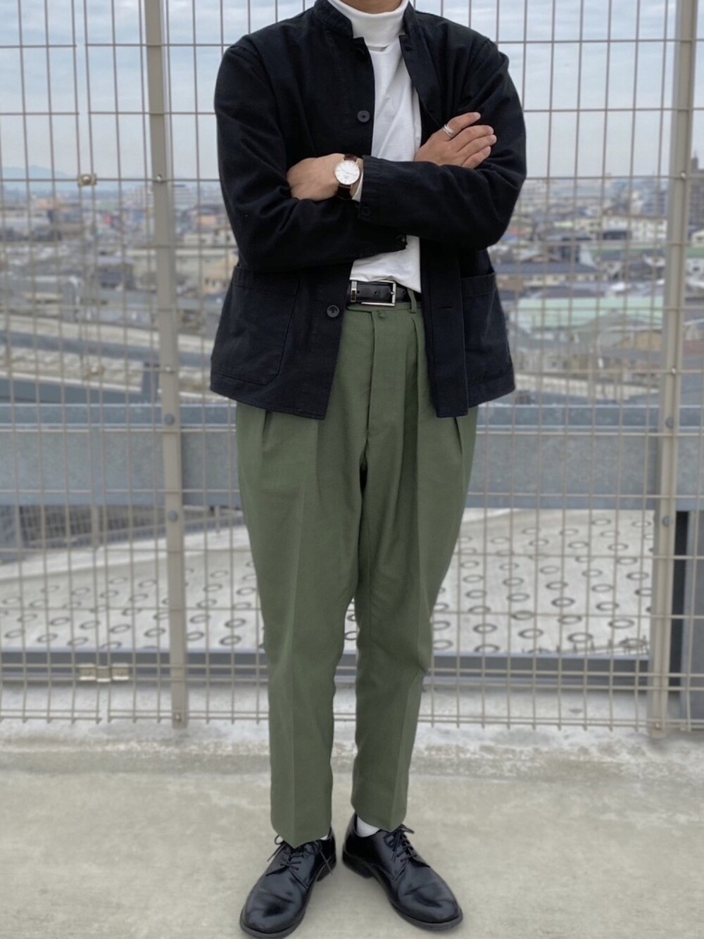 グリーン系のスラックス、ブラック系のカバーオールを着用したメンズの春コーディネートの1枚目の写真