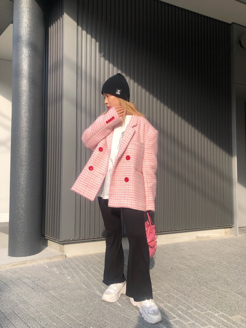 ピンク系のバッグ、ピンク系のテーラードジャケット、ブラック系のその他パンツを着用したレディースの春コーディネートの1枚目の写真