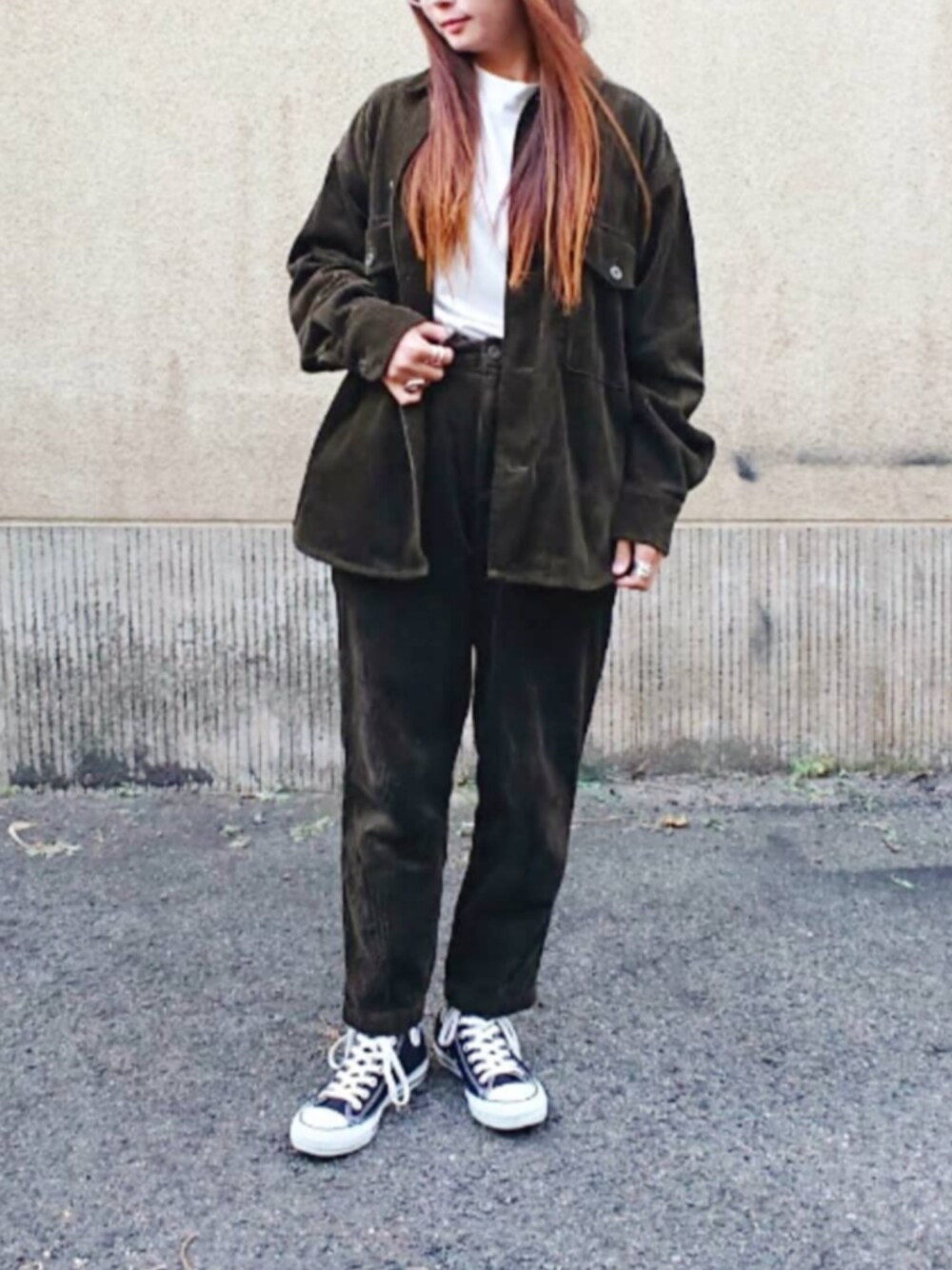 グリーン系のパンツ、ブラック系のスニーカーを着用したレディースの冬コーディネートの1枚目の写真