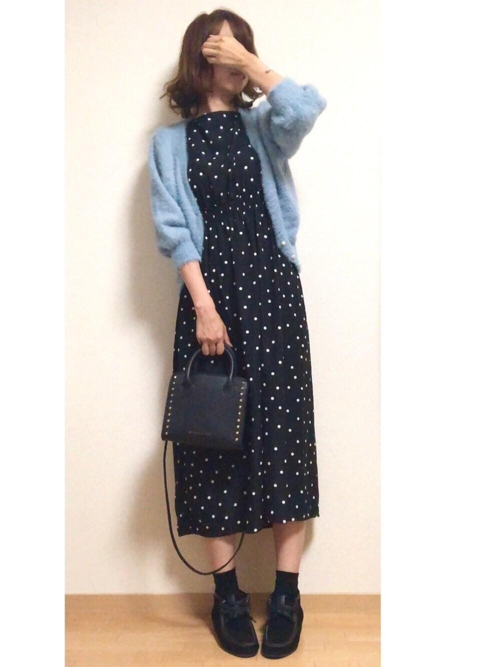 ブラック系のワンピース、ブルー系のニット/セーター、ブラック系のショルダーバッグを着用したレディースの秋コーディネートの1枚目の写真