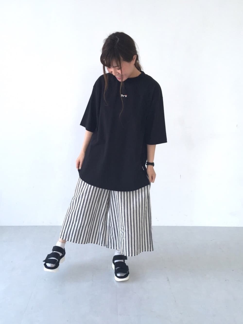 ブラック系のTシャツ/カットソー、ブラック系のその他パンツ、ブラック系のサンダルを着用したレディースの春コーディネートの1枚目の写真