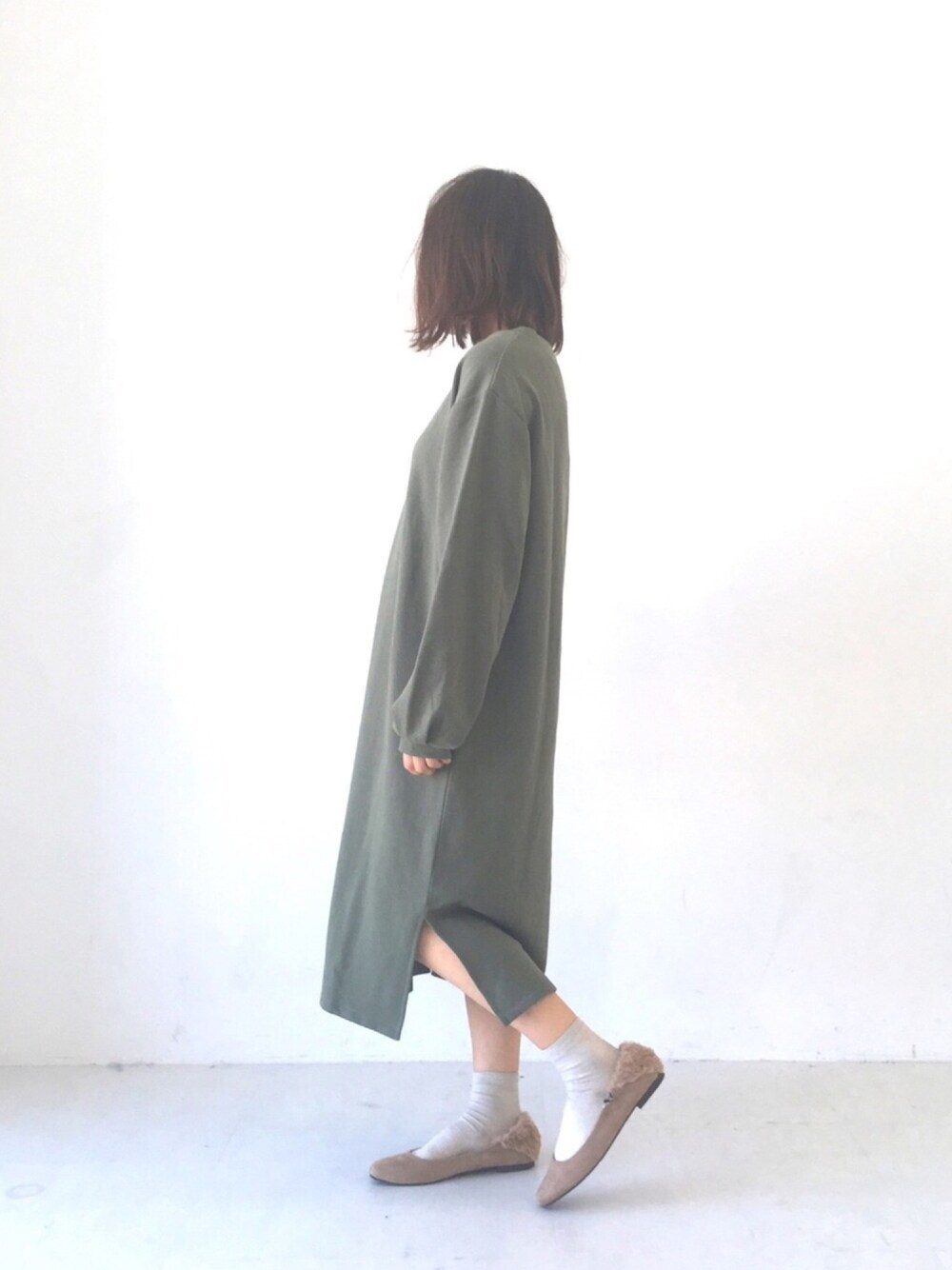 グリーン系のワンピース、ベージュ系のパンプス、グリーン系のその他を着用したレディースの秋コーディネートの1枚目の写真