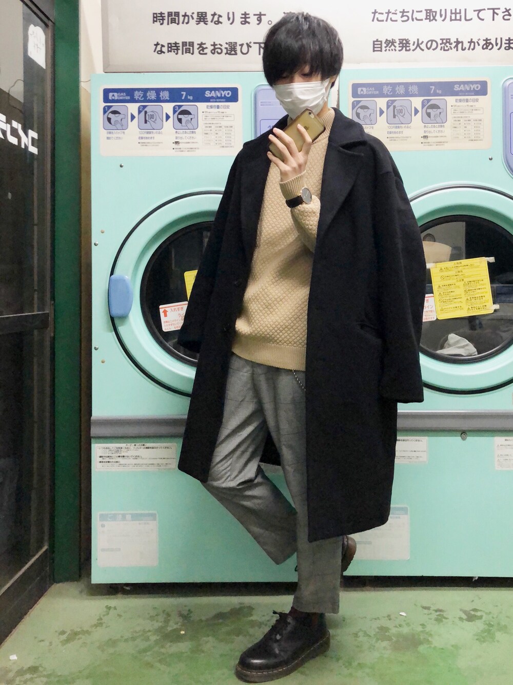 ブルー系のチェスターコート、ベージュ系のニット/セーター、グレー系のパンツを着用したメンズの冬コーディネートの1枚目の写真