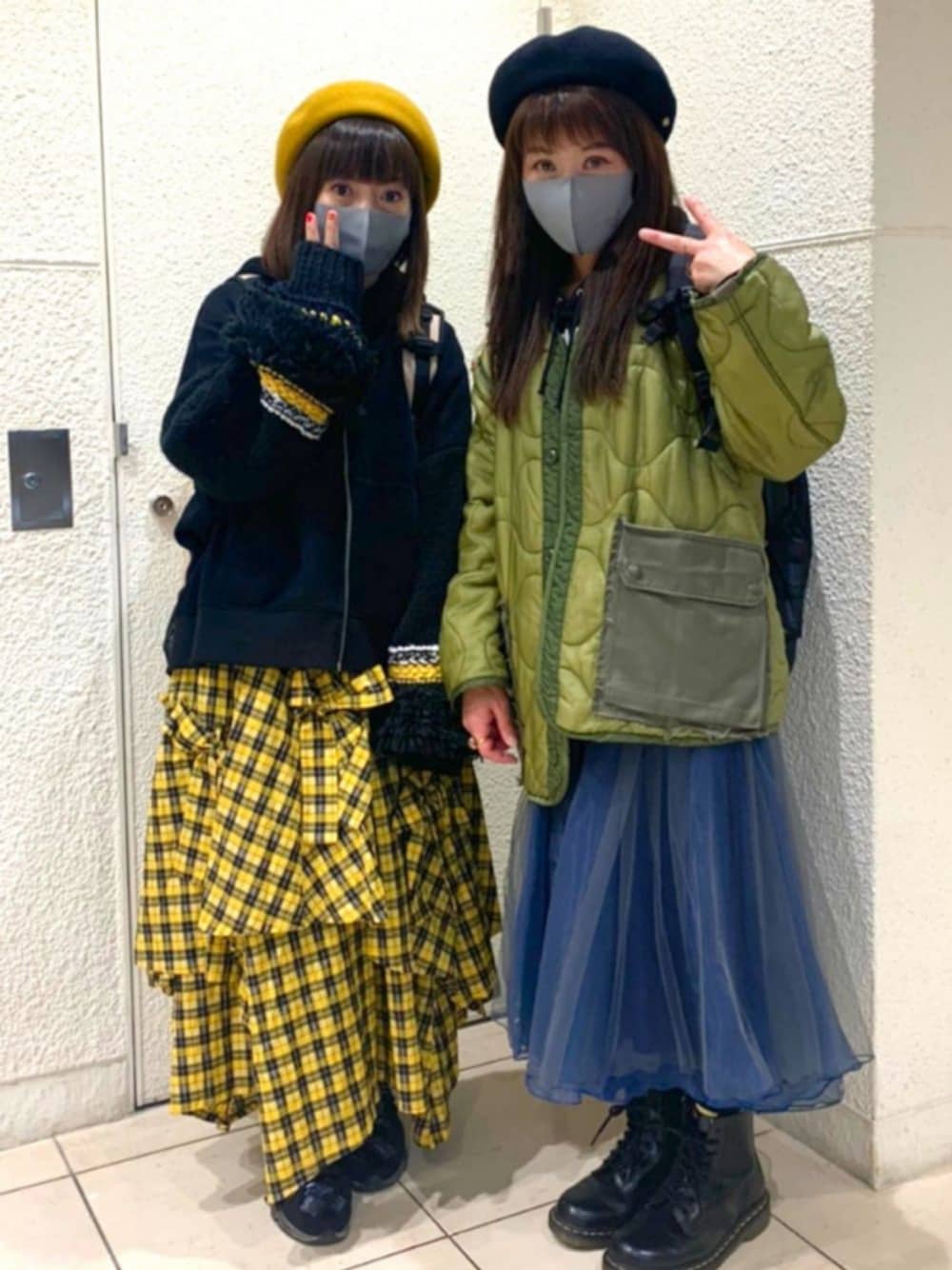 ブルー系のデニムパンツ、ブラック系のパーカー、イエロー系のスカートを着用したレディースの秋コーディネートの1枚目の写真