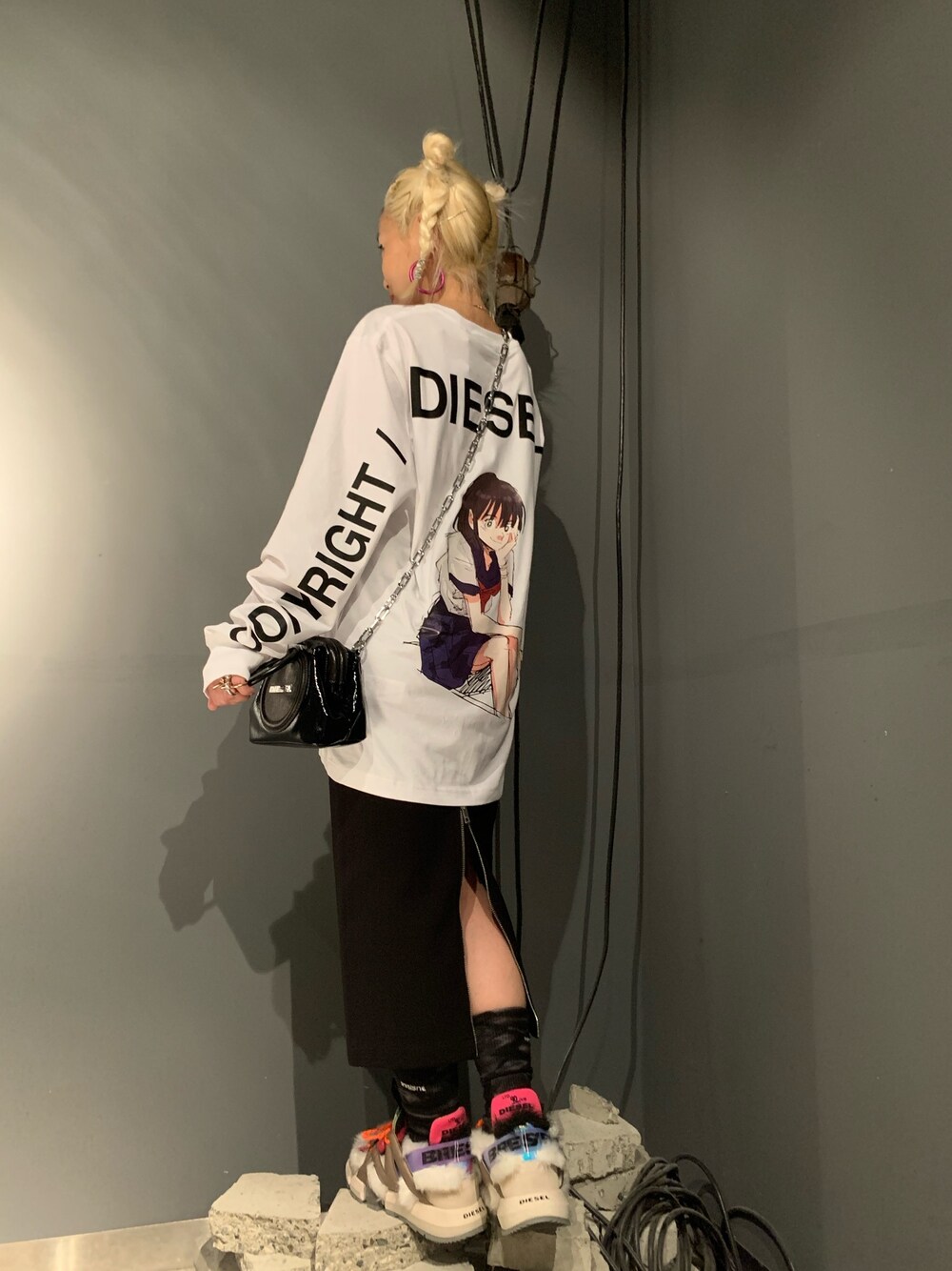 ホワイト系のTシャツ/カットソー、ブラック系のスカート、ホワイト系のスニーカーを着用したレディースの秋コーディネートの1枚目の写真