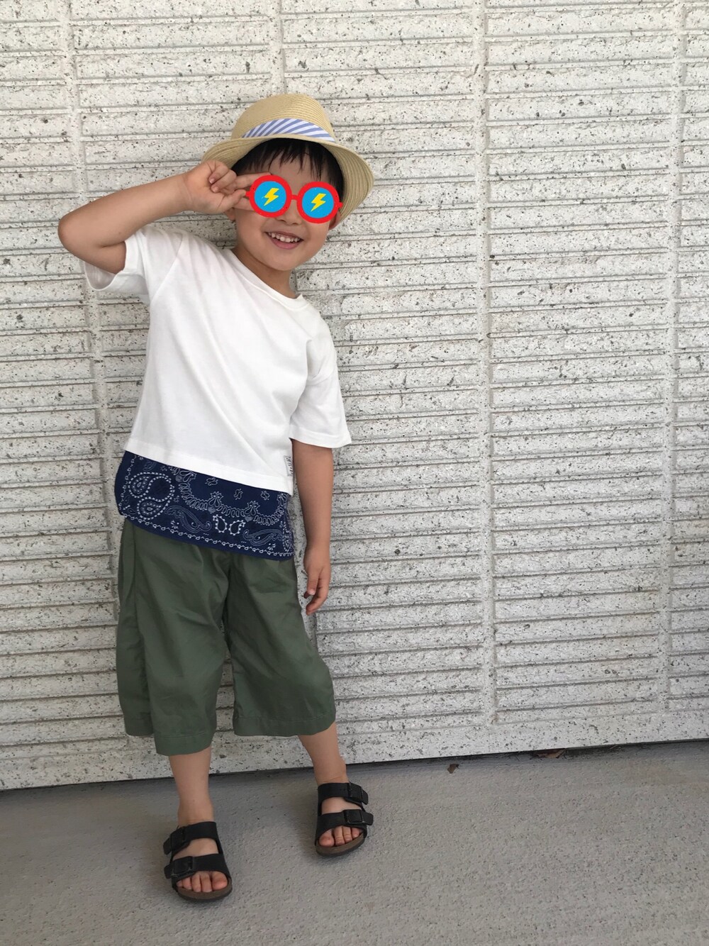 ホワイト系のTシャツ/カットソー、グリーン系のその他パンツ、ブラック系のサンダルを着用したキッズの夏コーディネートの1枚目の写真