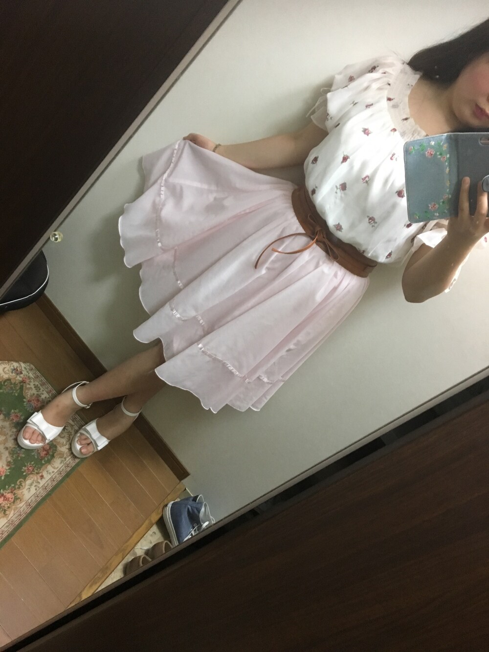 ピンク系のスカート、ホワイト系のトップス、ホワイト系のサンダルを着用したレディースの夏コーディネートの1枚目の写真