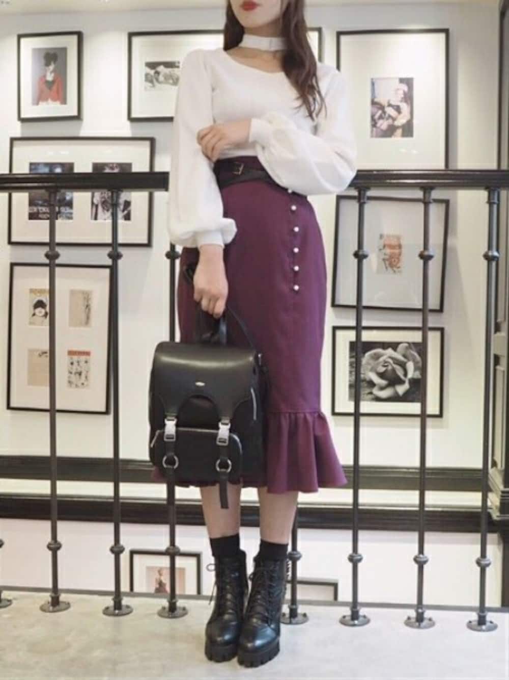 ホワイト系のニット/セーター、パープル系のスカート、ブラック系のバックパック/リュックを着用したレディースの秋コーディネートの1枚目の写真