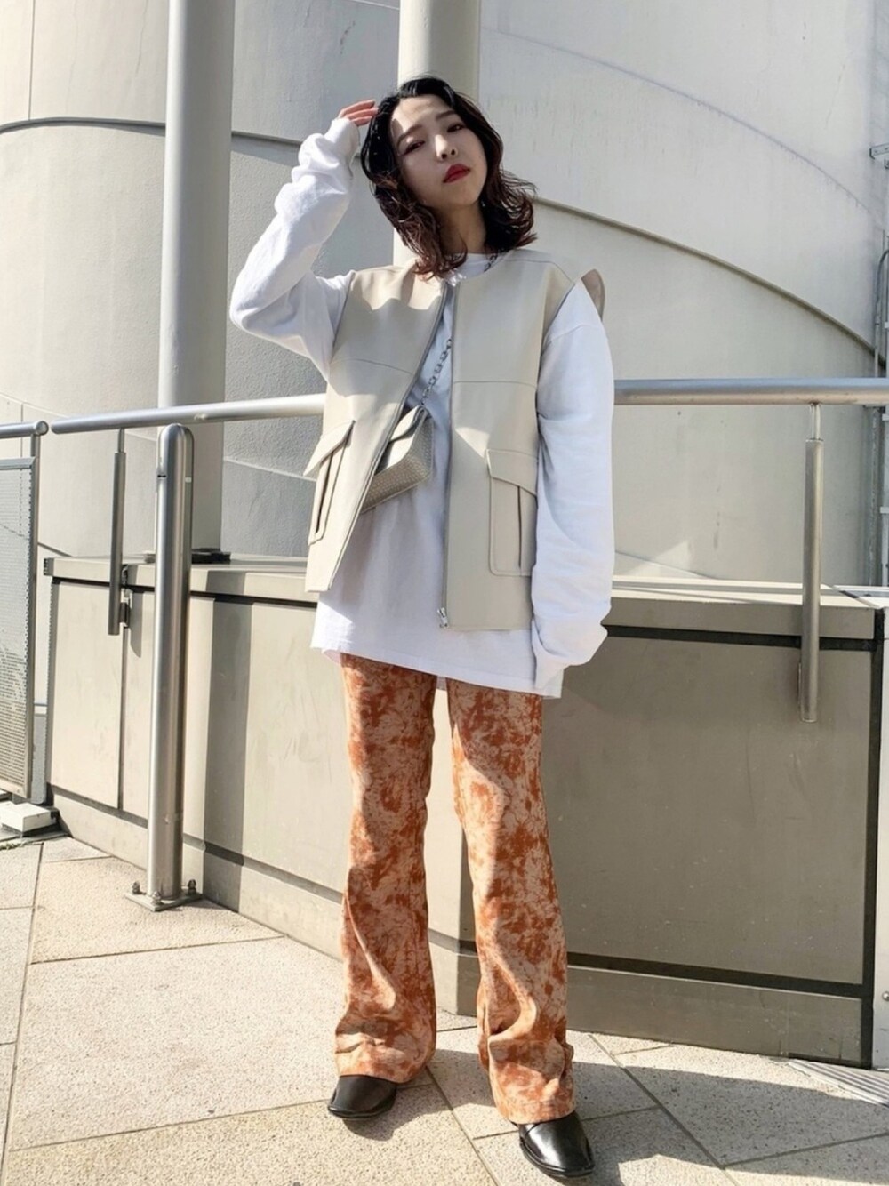 「パンツスタイル、低身長、柄パンツ、オレンジ、ベスト、ロンT、ボリューム袖、WHO’S WHO gallery、タイダイ柄、オーバーサイズ」｜「WHO'S WHO galleryのフェイクレザージップベスト（ベスト、ホワイト系）」を使った、36sakaimamiさん（レディース・152cm）の春コーディネートの1枚目の写真