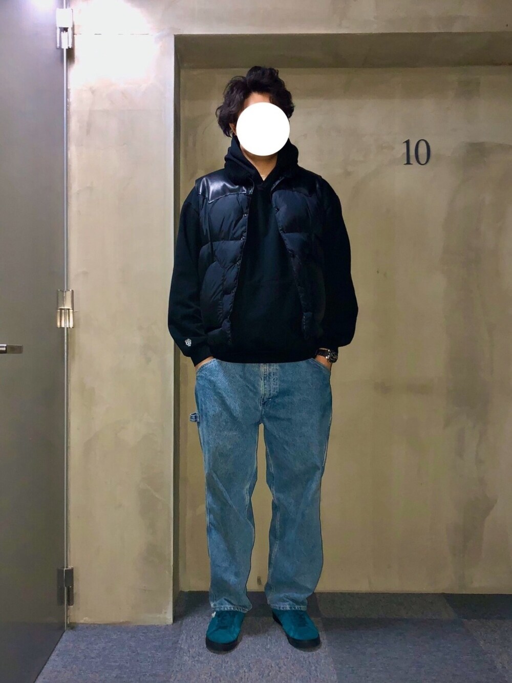 ブルー系のスニーカー、ブルー系のデニムパンツ、ブラック系のパーカーを着用したメンズの秋コーディネートの1枚目の写真